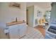 Bright kitchen with white cabinets, granite countertops, and a view to living room at 1605 Phillip Pl, Englewood, FL 34223