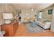 Living room with white couch, two armchairs, and a blue coffee table at 1605 Phillip Pl, Englewood, FL 34223