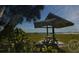 Park bench under a shaded pavilion by the water at 1605 Phillip Pl, Englewood, FL 34223