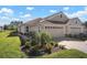 Two-story house with a tile roof, two-car garage, and lush landscaping at 1767 San Silvestro Dr, Venice, FL 34285