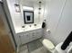 Modern bathroom with double vanity and updated fixtures at 218 Trailorama Dr, North Port, FL 34287