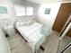 Second bedroom with light teal bedding and coastal decor at 218 Trailorama Dr, North Port, FL 34287