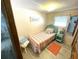Small bedroom with a light teal and coral bedding set at 218 Trailorama Dr, North Port, FL 34287