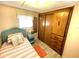 Bedroom with wood closet and light teal bedding at 218 Trailorama Dr, North Port, FL 34287