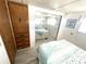 Bedroom with mirrored closet doors and coastal decor at 218 Trailorama Dr, North Port, FL 34287