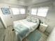 Cozy bedroom with a light teal bedding set and coastal decor at 218 Trailorama Dr, North Port, FL 34287