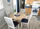 Bright dining area with a round table and four chairs, adjacent to the kitchen at 218 Trailorama Dr, North Port, FL 34287