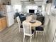 Cozy dining area with a round table and four chairs, open to the living room at 218 Trailorama Dr, North Port, FL 34287