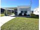 Landscaped yard with white mobile home and carport at 218 Trailorama Dr, North Port, FL 34287