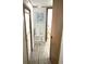 Clean hallway with light flooring and beach-themed decor at 218 Trailorama Dr, North Port, FL 34287