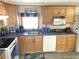 Kitchen with wood cabinets, updated countertops, and a built-in microwave at 218 Trailorama Dr, North Port, FL 34287