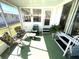 Relaxing screened porch with seating area at 218 Trailorama Dr, North Port, FL 34287