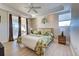 Main bedroom with king bed, light wood floors and private balcony at 235 Base E Ave # 201, Venice, FL 34285