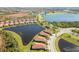 Aerial view of community with lake and homes at 23924 Skyflower Ct, Venice, FL 34293