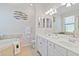 Double vanity bathroom with soaking tub and walk-in shower at 23924 Skyflower Ct, Venice, FL 34293