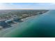 Stunning aerial view of the coastline featuring luxurious beachfront condos with sparkling turquoise water at 250 Santa Maria St # 219, Venice, FL 34285