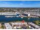 Stunning aerial view of the building's location, surrounded by water, marina, and city at 250 Santa Maria St # 219, Venice, FL 34285