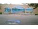 Public art display with an ocean mural and a circular map inlayed on the paver courtyard at 250 Santa Maria St # 219, Venice, FL 34285