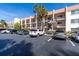 Condo building exterior showcasing parking and landscaping at 250 Santa Maria St # 219, Venice, FL 34285