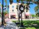Historic KMI Building with a clock tower, shaded bench, and restaurants nearby at 250 Santa Maria St # 219, Venice, FL 34285