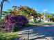 Landscaped grounds with vibrant bougainvillea and a stately building in the background create a lush atmosphere at 250 Santa Maria St # 219, Venice, FL 34285