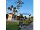 Scenic park view with a bench, lush greenery, a clock tower, and a kiosk for information and refreshments at 250 Santa Maria St # 219, Venice, FL 34285