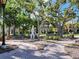 Picturesque park scene with lush greenery, trees, a fountain, and benches, inviting relaxation and enjoyment at 250 Santa Maria St # 219, Venice, FL 34285