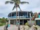 Exterior view of a circular beach restaurant with outdoor seating and a beachfront location at 250 Santa Maria St # 219, Venice, FL 34285