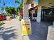 Inviting restaurant storefront with outdoor seating and a 'Legendary Happy Hour' sign, located in a lively neighborhood at 250 Santa Maria St # 219, Venice, FL 34285