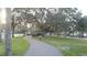 Scenic street view with sidewalks winding through lush green lawns and mature trees at 250 Santa Maria St # 219, Venice, FL 34285