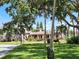 Picturesque street view of a community building with lush green lawns and shade trees at 250 Santa Maria St # 219, Venice, FL 34285