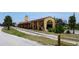 View of the train station, featuring shade coverings, nearby railroad tracks and grass at 250 Santa Maria St # 219, Venice, FL 34285