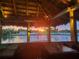 Scenic sunset view from an outdoor, covered dining area overlooking the tranquil waterfront at 250 Santa Maria St # 219, Venice, FL 34285