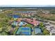 Aerial view showing community pool, tennis courts, and clubhouse at 2539 Brassica Dr, North Port, FL 34289