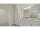 Double vanity bathroom with a large mirror and walk-in shower at 2539 Brassica Dr, North Port, FL 34289