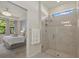 Clean bathroom with a large glass shower and view into bedroom at 2539 Brassica Dr, North Port, FL 34289