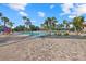 Community pool with lounge chairs and palms at 2539 Brassica Dr, North Port, FL 34289