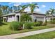 Single-story home with a two-car garage and landscaped lawn at 2539 Brassica Dr, North Port, FL 34289