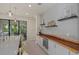 Kitchen features a long live-edge wood counter and a wine cooler at 2539 Brassica Dr, North Port, FL 34289