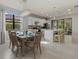 Modern kitchen with white cabinets, an island and eat in dining area at 2539 Brassica Dr, North Port, FL 34289
