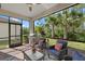 Screened lanai with seating and a built-in grill at 2539 Brassica Dr, North Port, FL 34289