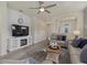 Cozy living room featuring a built-in fireplace and TV at 2539 Brassica Dr, North Port, FL 34289