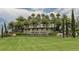 Elegant stone signage for Toscana Isles, set against a backdrop of manicured landscaping and palm trees at 254 Toscavilla Blvd, Nokomis, FL 34275