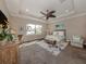 Bedroom featuring tray ceiling, ceiling fan, and an abundance of natural light with a water view at 254 Toscavilla Blvd, Nokomis, FL 34275