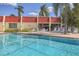 Community pool with lounge chairs at 260 Santa Maria St # 111, Venice, FL 34285