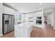 Modern kitchen with white cabinets, stainless steel appliances, and an island at 26056 Seastone Dr, Englewood, FL 34223