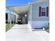 Mobile home with carport and golf cart at 334 Blackburn Blvd, North Port, FL 34287