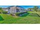 Landscaped backyard with screened pool and patio area at 4245 Whispering Oaks Dr, North Port, FL 34287