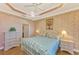 Main bedroom with ceiling fan, large bed, and access to the patio at 4245 Whispering Oaks Dr, North Port, FL 34287