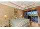 Main bedroom with sliding doors leading to a private patio at 4245 Whispering Oaks Dr, North Port, FL 34287
